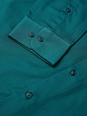 Close-up of a teal shirt with buttons and a pocket